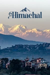 Snow-capped Himalayan peaks above a Himachal Pradesh valley town